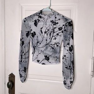 Sheer Cowl neck long sleeve with black floral design.